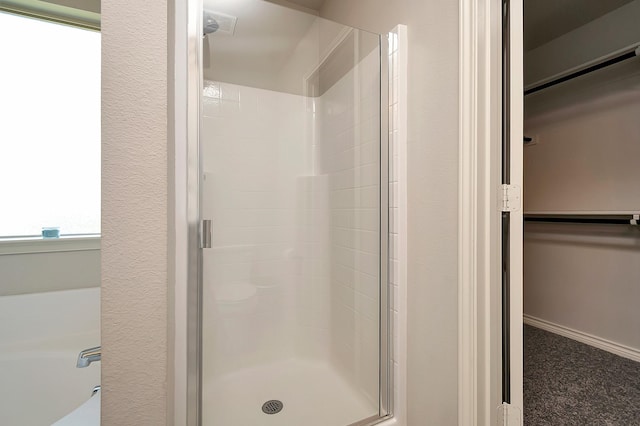 bathroom with shower with separate bathtub