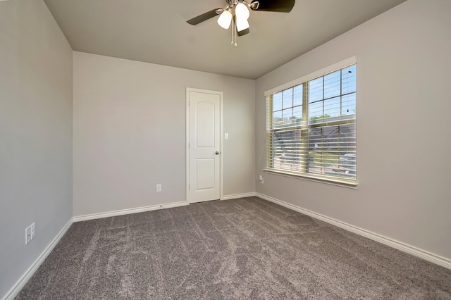 unfurnished room featuring ceiling fan and dark colored carpet