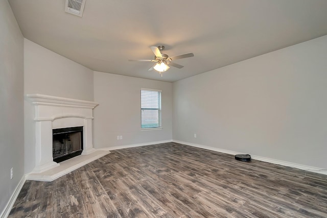 unfurnished living room featuring ceiling fan and dark hardwood / wood-style flooring