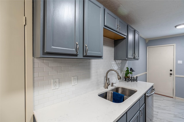 kitchen featuring gray cabinets, sink, backsplash, stainless steel dishwasher, and a textured ceiling