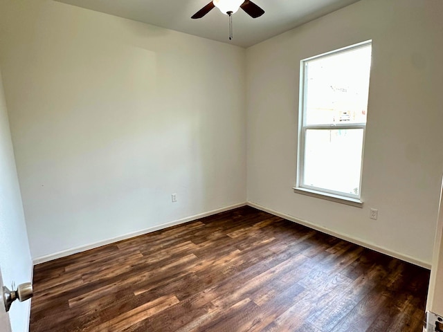 empty room with dark wood-type flooring and ceiling fan