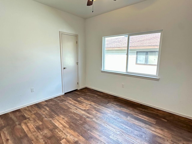 spare room with dark hardwood / wood-style floors and ceiling fan