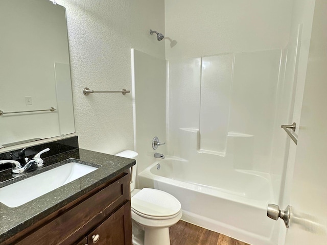 full bathroom featuring vanity, toilet, hardwood / wood-style floors, and shower / bathing tub combination