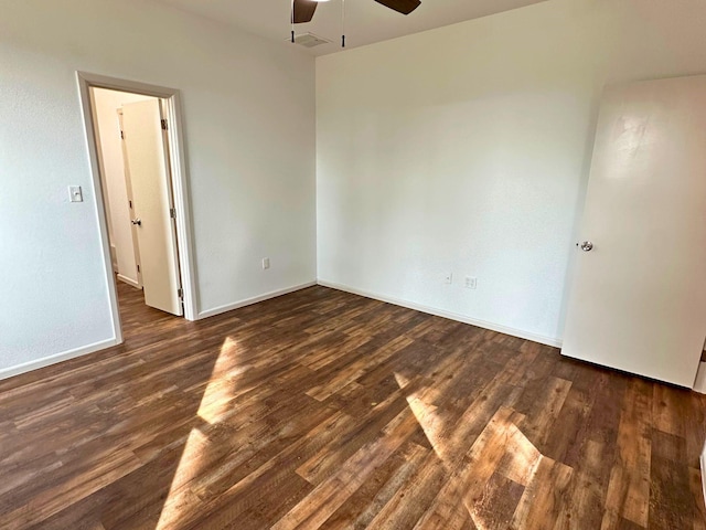 spare room featuring ceiling fan and dark hardwood / wood-style floors