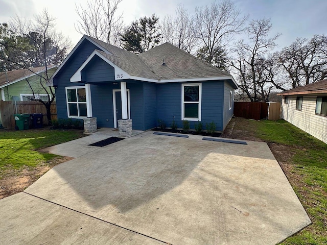 view of front of property featuring a front lawn and a patio