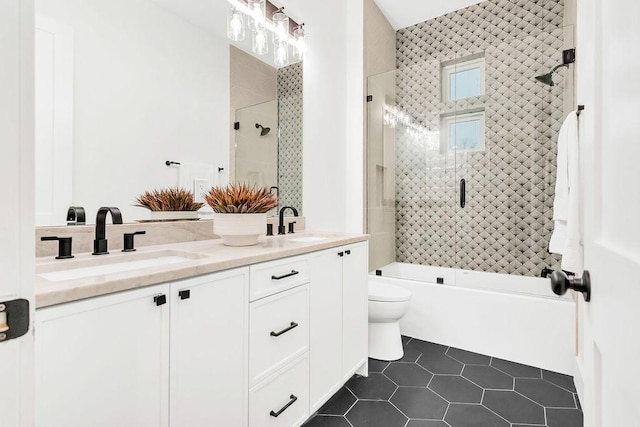 full bathroom featuring enclosed tub / shower combo, tile patterned floors, toilet, and vanity