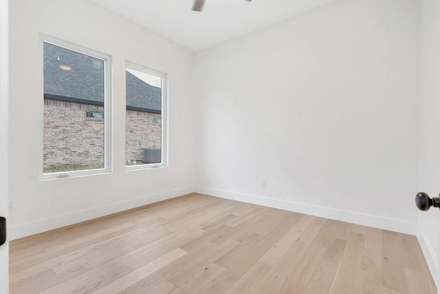 empty room with light hardwood / wood-style flooring, plenty of natural light, and ceiling fan