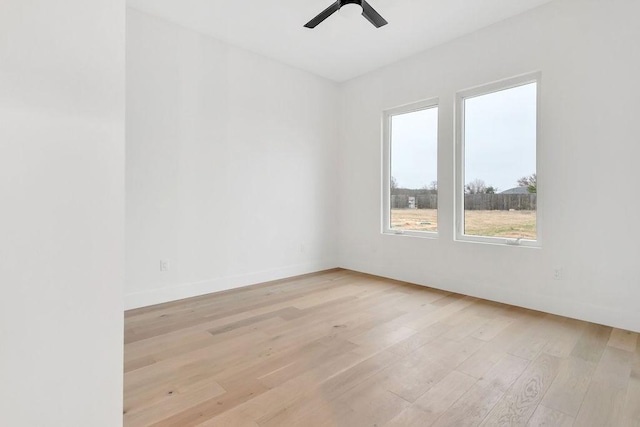 unfurnished room with ceiling fan and light wood-type flooring