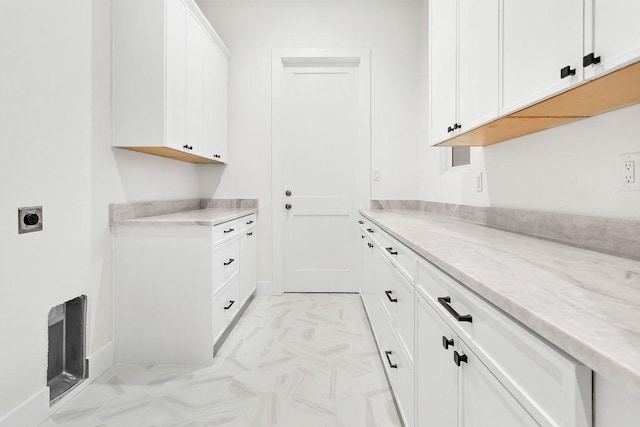 laundry area with cabinets and hookup for an electric dryer