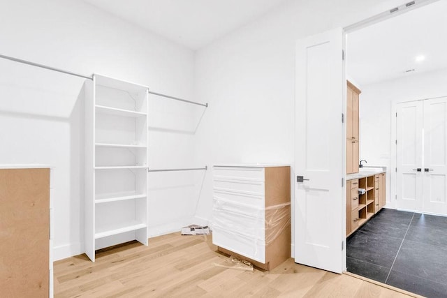 walk in closet featuring wood-type flooring