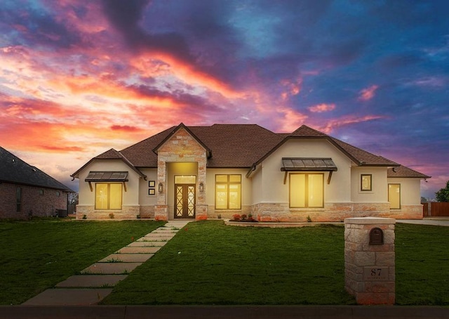 view of front of home featuring a yard and french doors