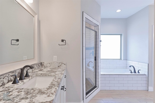 bathroom with independent shower and bath and vanity