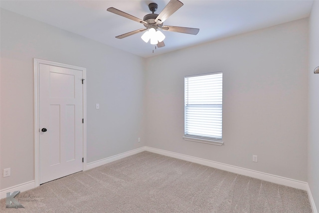 empty room featuring light colored carpet and ceiling fan