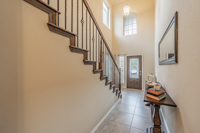 tiled foyer entrance featuring a high ceiling and plenty of natural light