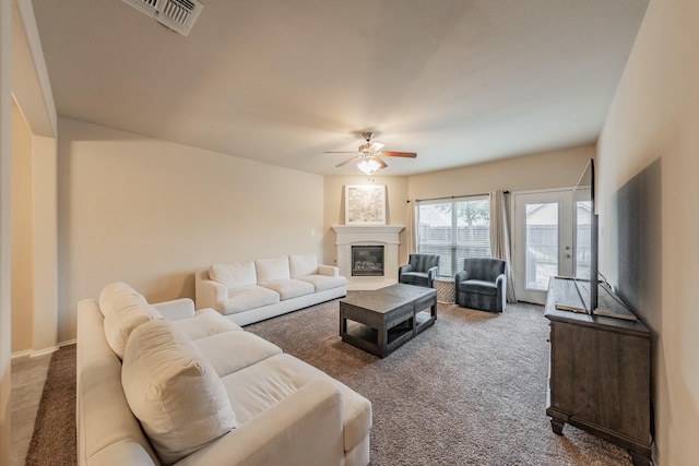 living room featuring carpet flooring and ceiling fan