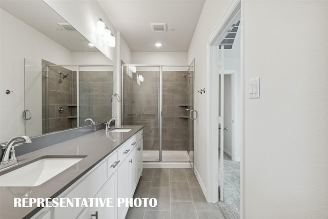 bathroom featuring vanity, tile patterned flooring, and a shower with door