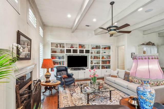 living room with wood finished floors, beamed ceiling, ceiling fan, recessed lighting, and a premium fireplace