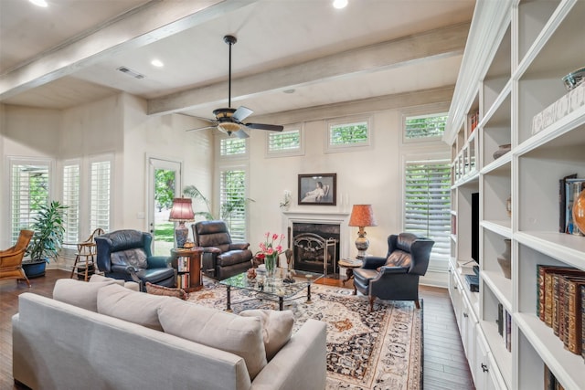 living room featuring ceiling fan, visible vents, beam ceiling, and hardwood / wood-style flooring