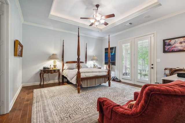 bedroom with visible vents, ornamental molding, hardwood / wood-style floors, access to outside, and a raised ceiling