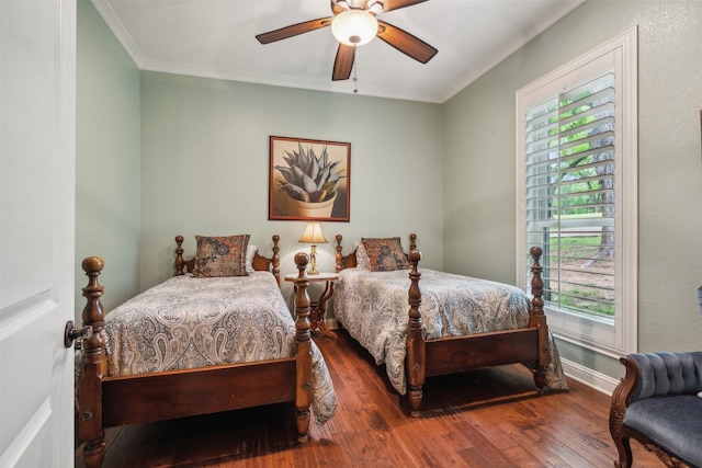 bedroom featuring baseboards, ornamental molding, ceiling fan, and wood finished floors