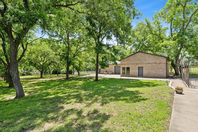 ranch-style home with brick siding, a gate, a front lawn, and fence