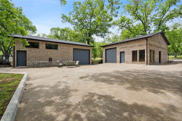 view of home's exterior with brick siding and a garage
