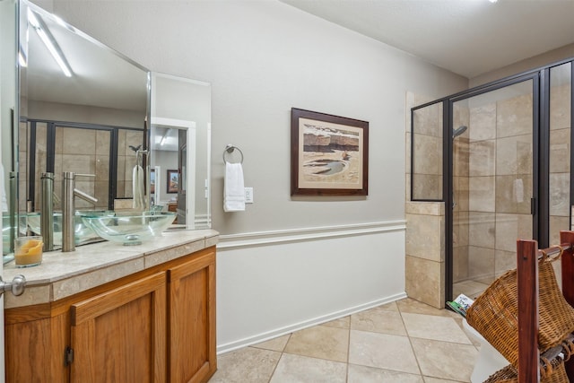 full bathroom featuring vanity, tile patterned floors, and a shower stall
