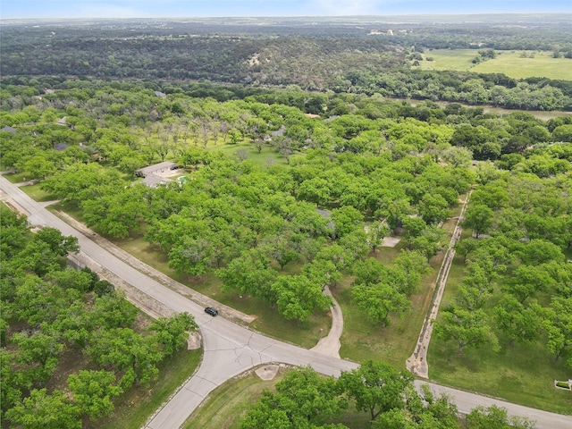 birds eye view of property featuring a view of trees