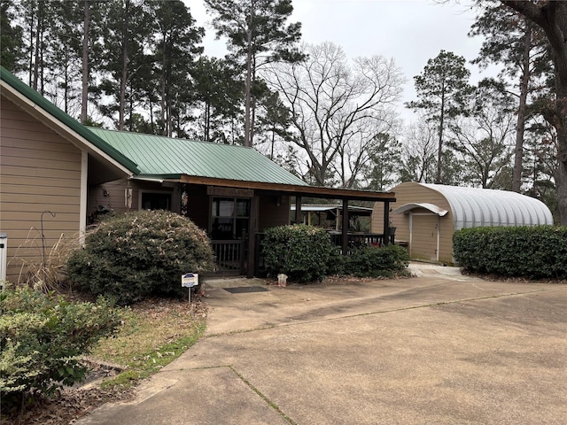 view of front of home featuring a porch and metal roof