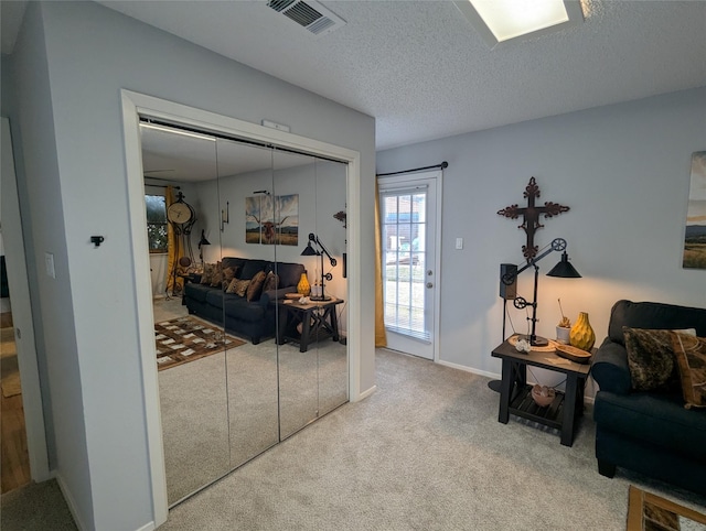 living room featuring carpet flooring and a textured ceiling