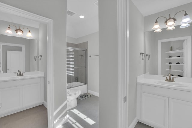 full bathroom featuring vanity, toilet, tile patterned floors, and bath / shower combo with glass door