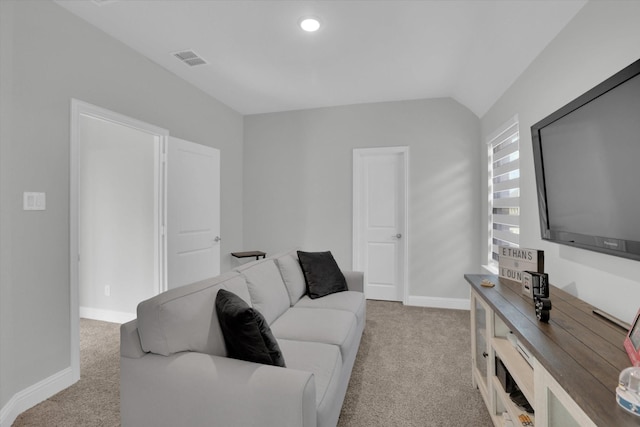 carpeted living room featuring vaulted ceiling