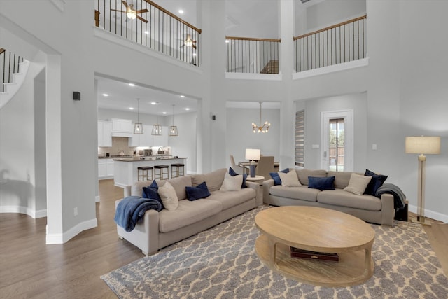 living room with an inviting chandelier and hardwood / wood-style flooring