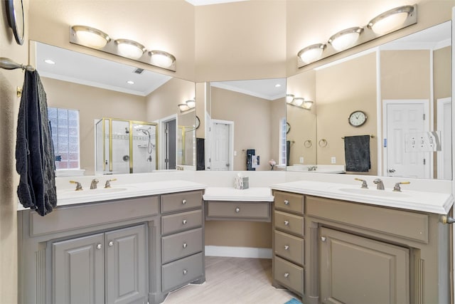 bathroom featuring a shower with door, ornamental molding, and vanity