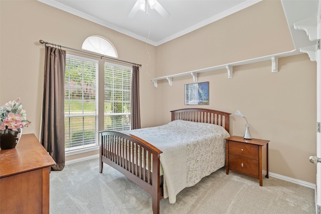 carpeted bedroom featuring ornamental molding and ceiling fan