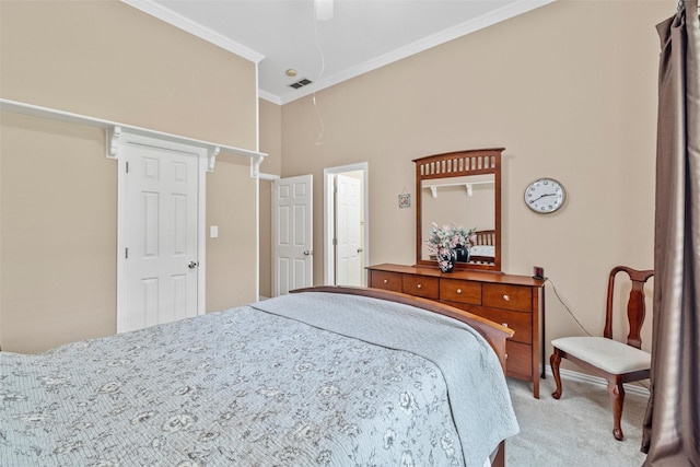 carpeted bedroom featuring ornamental molding and ceiling fan