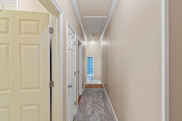 hallway with light carpet and crown molding