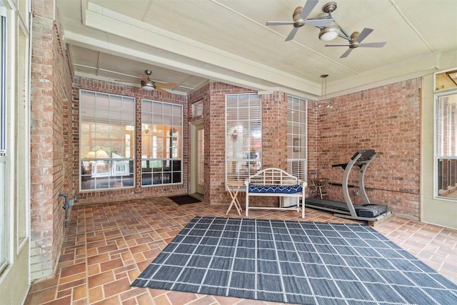 unfurnished sunroom with plenty of natural light and ceiling fan