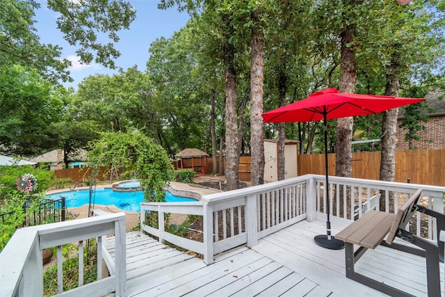 wooden terrace featuring a fenced in pool and a shed