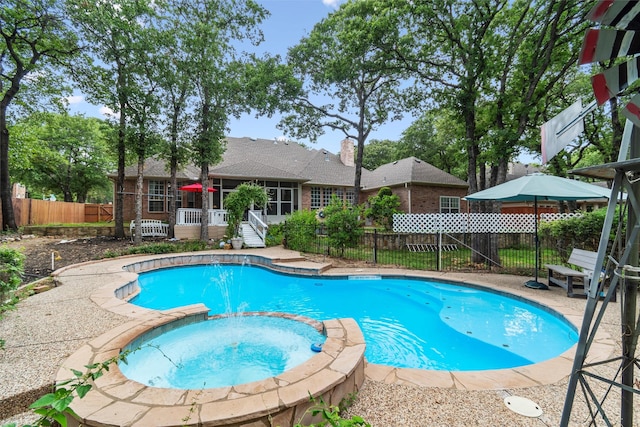 view of pool featuring an in ground hot tub