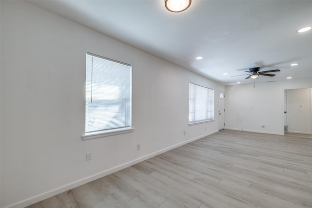 spare room featuring ceiling fan and light hardwood / wood-style floors