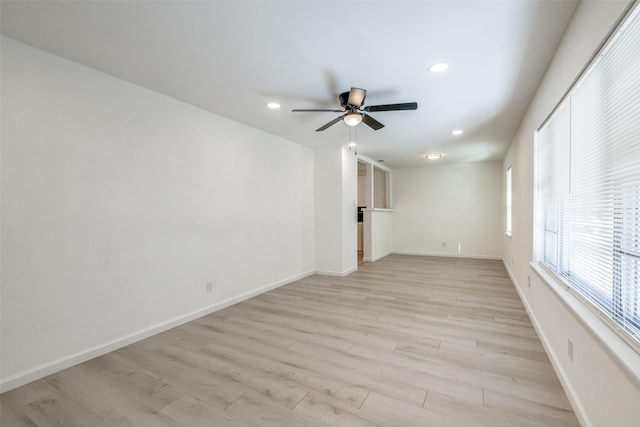 empty room featuring ceiling fan and light wood-type flooring