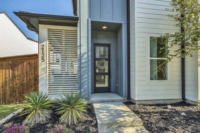 2125 Bird St, Fort Worth, TX 76111 - doorway to property featuring fence and board and batten siding