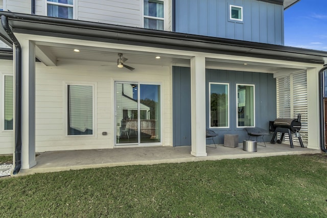 2125 Bird St, Fort Worth, TX 76111 - back of house with board and batten siding, a yard, a patio area, and a ceiling fan