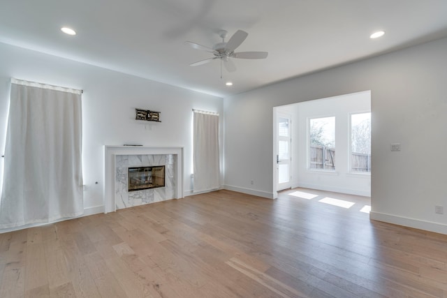 2125 Bird St, Fort Worth, TX 76111 - unfurnished living room with ceiling fan, a fireplace, wood finished floors, and recessed lighting