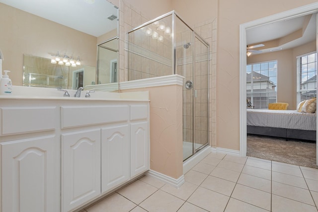 bathroom with tile patterned flooring, vanity, and walk in shower