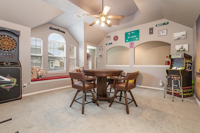 dining room with light carpet, vaulted ceiling, and ceiling fan