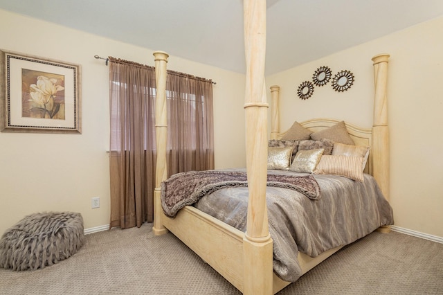 bedroom featuring light colored carpet and vaulted ceiling