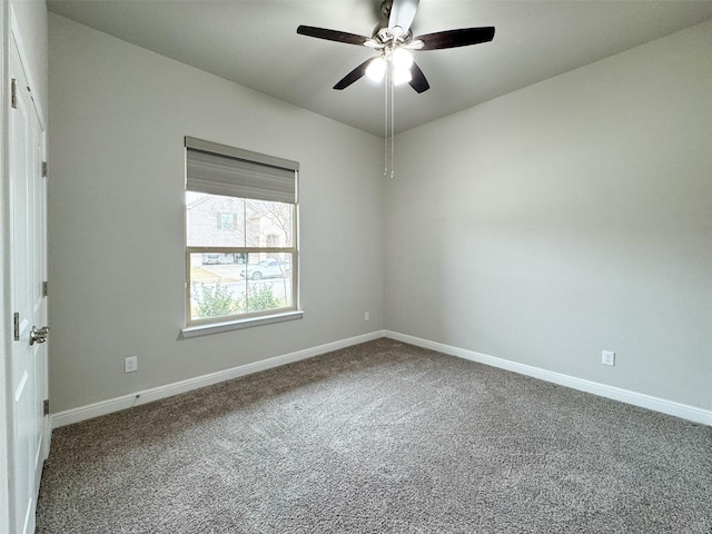 carpeted spare room featuring ceiling fan