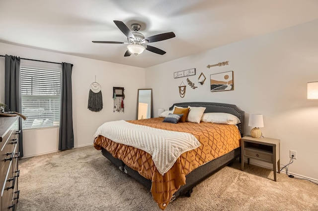 bedroom featuring ceiling fan and light carpet